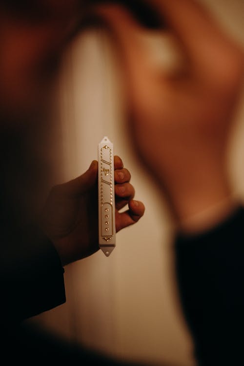 Person Holding a Mezuzah