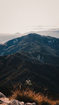 A stunning landscape view of distant mountain ranges during twilight, showcasing natural beauty.