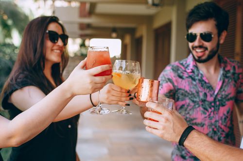 Free A group of friends toasting with drinks at an outdoor gathering, celebrating with joy and laughter. Stock Photo