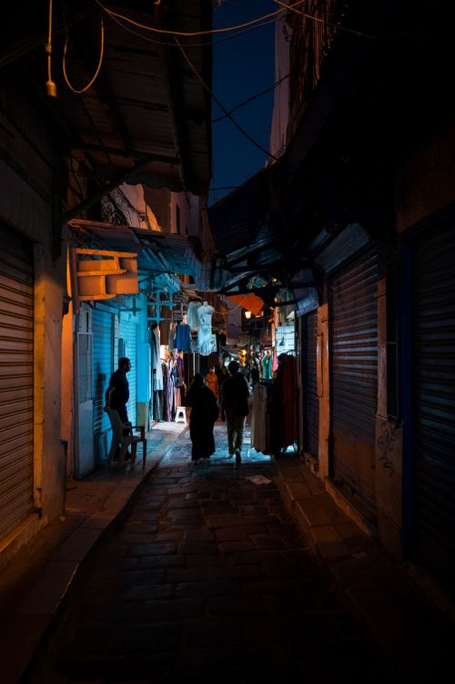 Free Explore the bustling life of Tunis Medina at night, illuminated by vibrant street lights. Stock Photo
