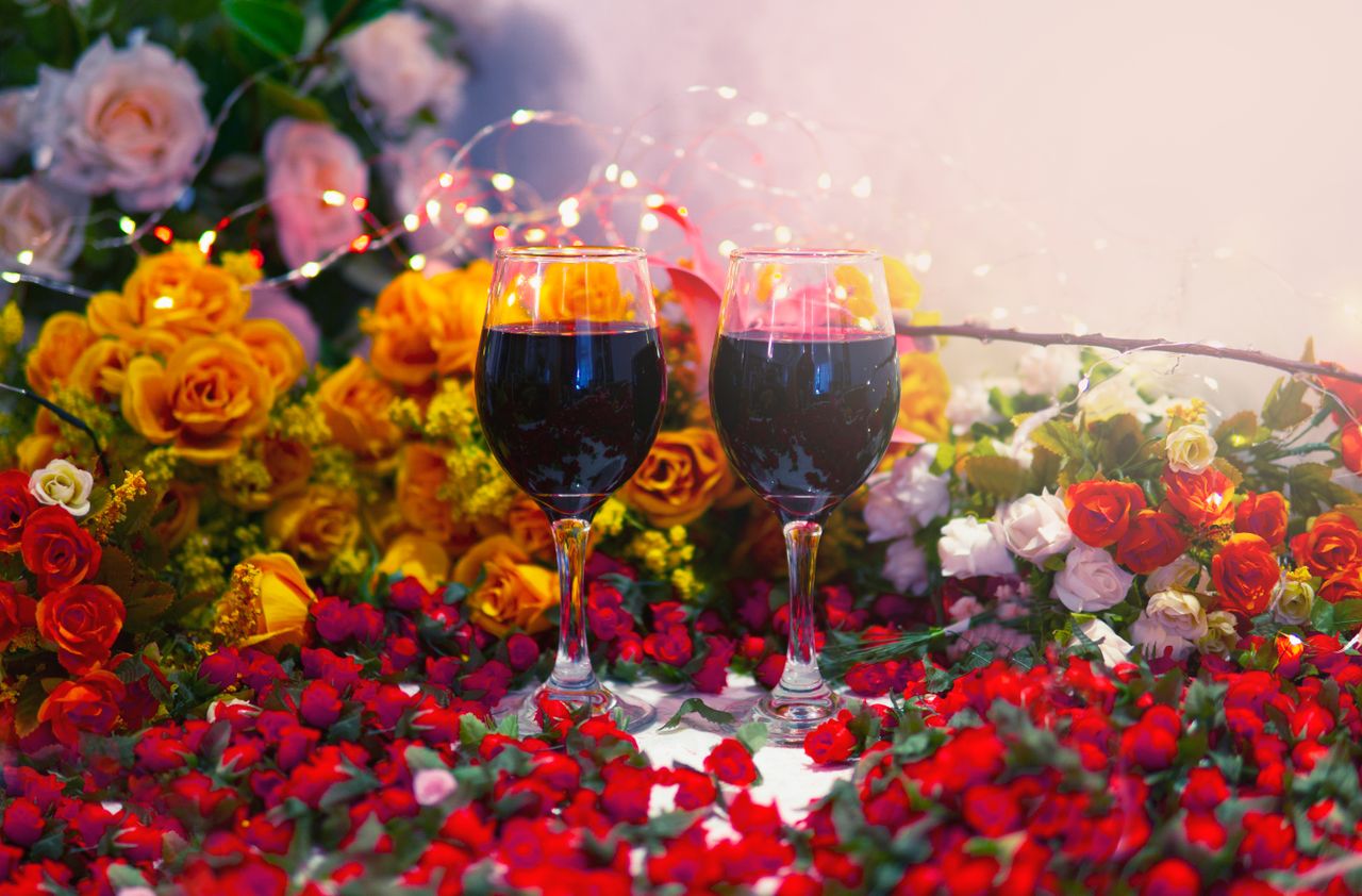 elegant romantic setting with red wine and vibrant roses perfect for c