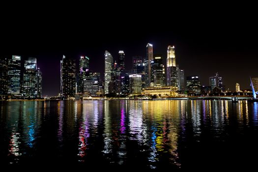 Stunning night view of Singapore's illuminated skyline reflecting on the water.