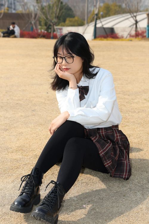 Free A young woman sitting in a park in Hefei, China, enjoying a sunny day. Stock Photo