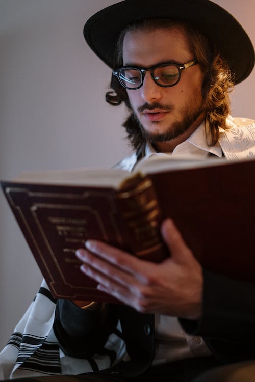 Free Young Man Reading a Book in Hebrew Stock Photo