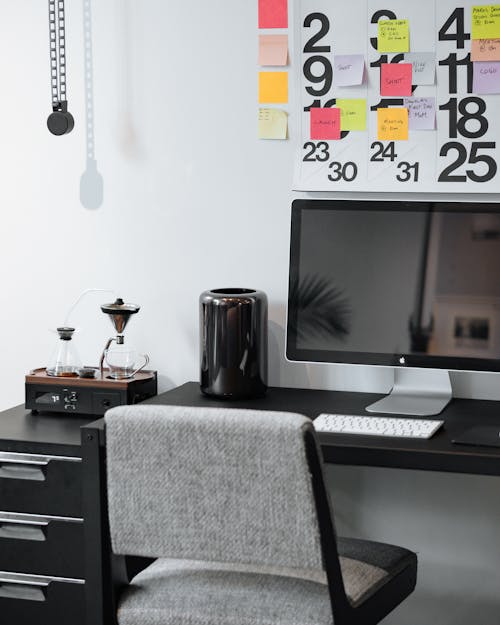 Silver Imac on Black Wooden Desk