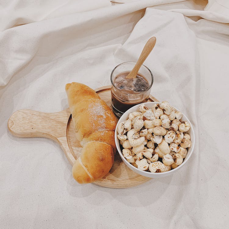 Free  Food And Drink on A Wooden Board On White Table Cloth Stock Photo