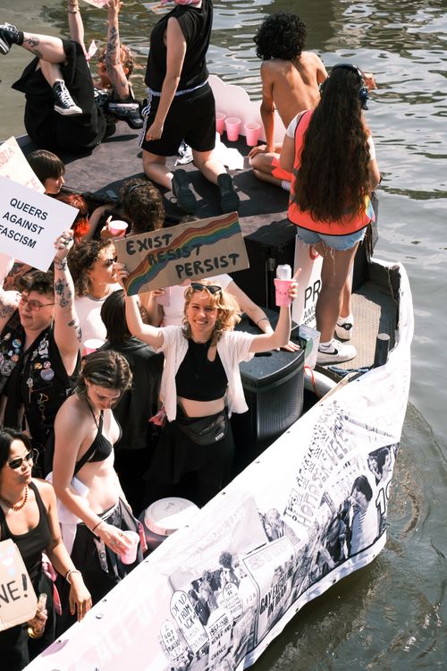 Free Vibrant pride parade celebration on a canal boat in Amsterdam, showcasing unity and diversity. Stock Photo
