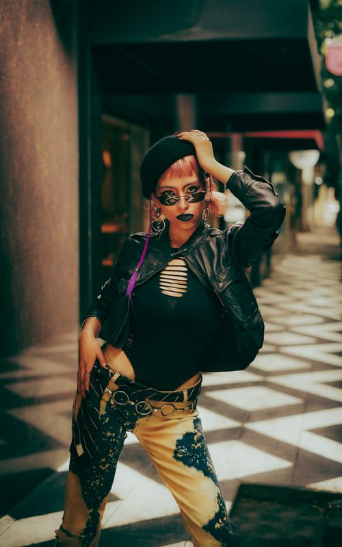 Free Model in edgy urban fashion posing confidently outdoors with geometric patterns. Stock Photo