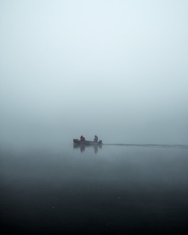 People In A Boat on A Foggy Day