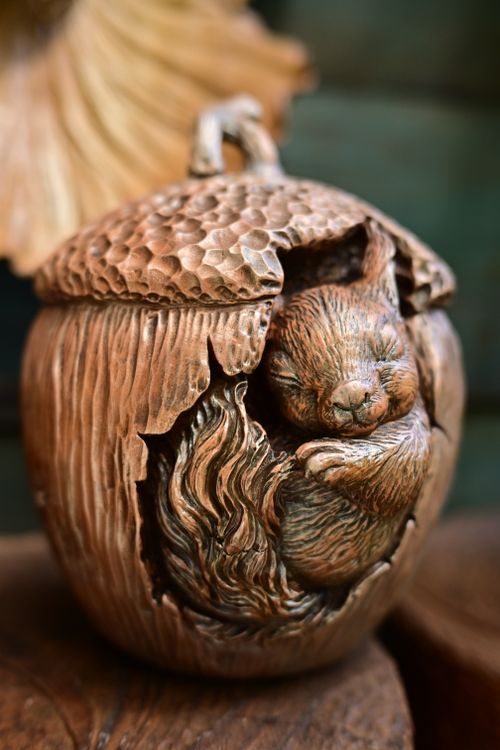 Free A detailed sculpture of a squirrel nestled in an acorn, showcasing artisanal craftsmanship. Stock Photo