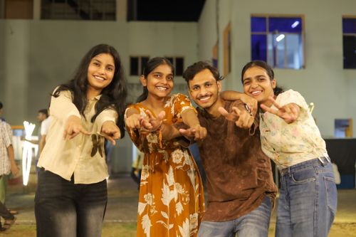 Free A cheerful group of friends posing together outdoors at night in Kharagpur, India. Stock Photo