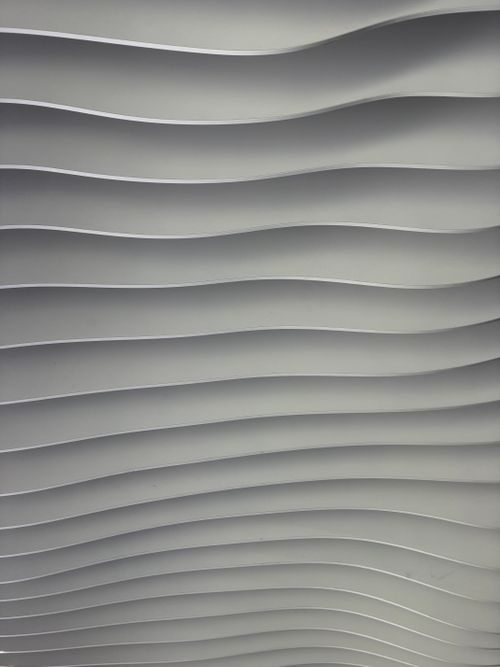 Free Artistic wavy grey wall design showcasing modern minimalist abstract style. Stock Photo
