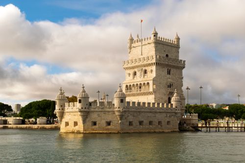 Free Historic Torre de Belém by the Tagus River in Lisbon, Portugal, against a cloudy sky. Stock Photo
