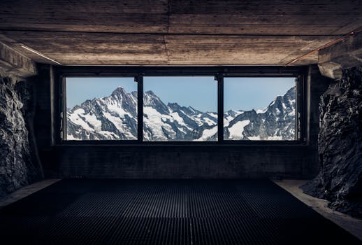 Captivating view of the snow-covered Swiss Alps through a large window in Grindelwald.