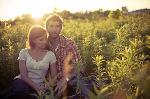 Free Man and Woman Hugging on the Center of Plants Stock Photo
