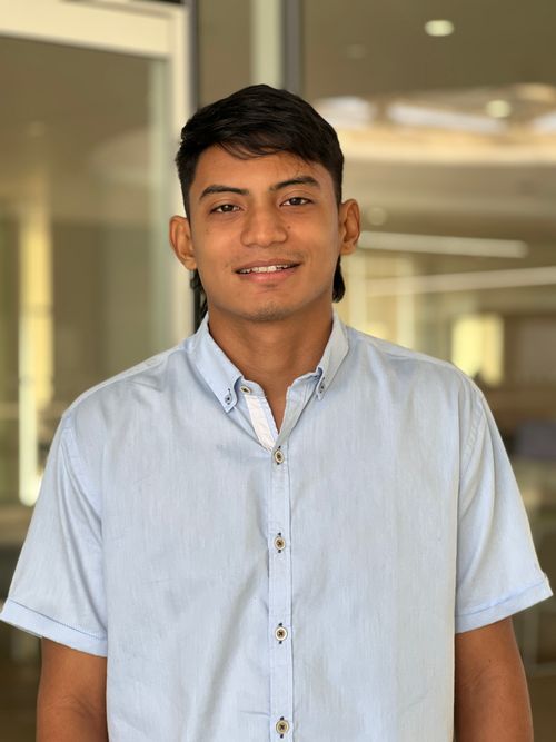 Free A professional portrait of a young man in a light-filled modern office setting. Stock Photo