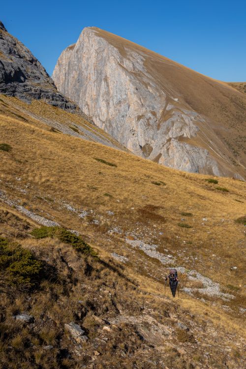 Free A lone hiker traverses a rugged mountain trail in the Municipality of Tetovo, showcasing the majestic landscape of North Macedonia. Stock Photo