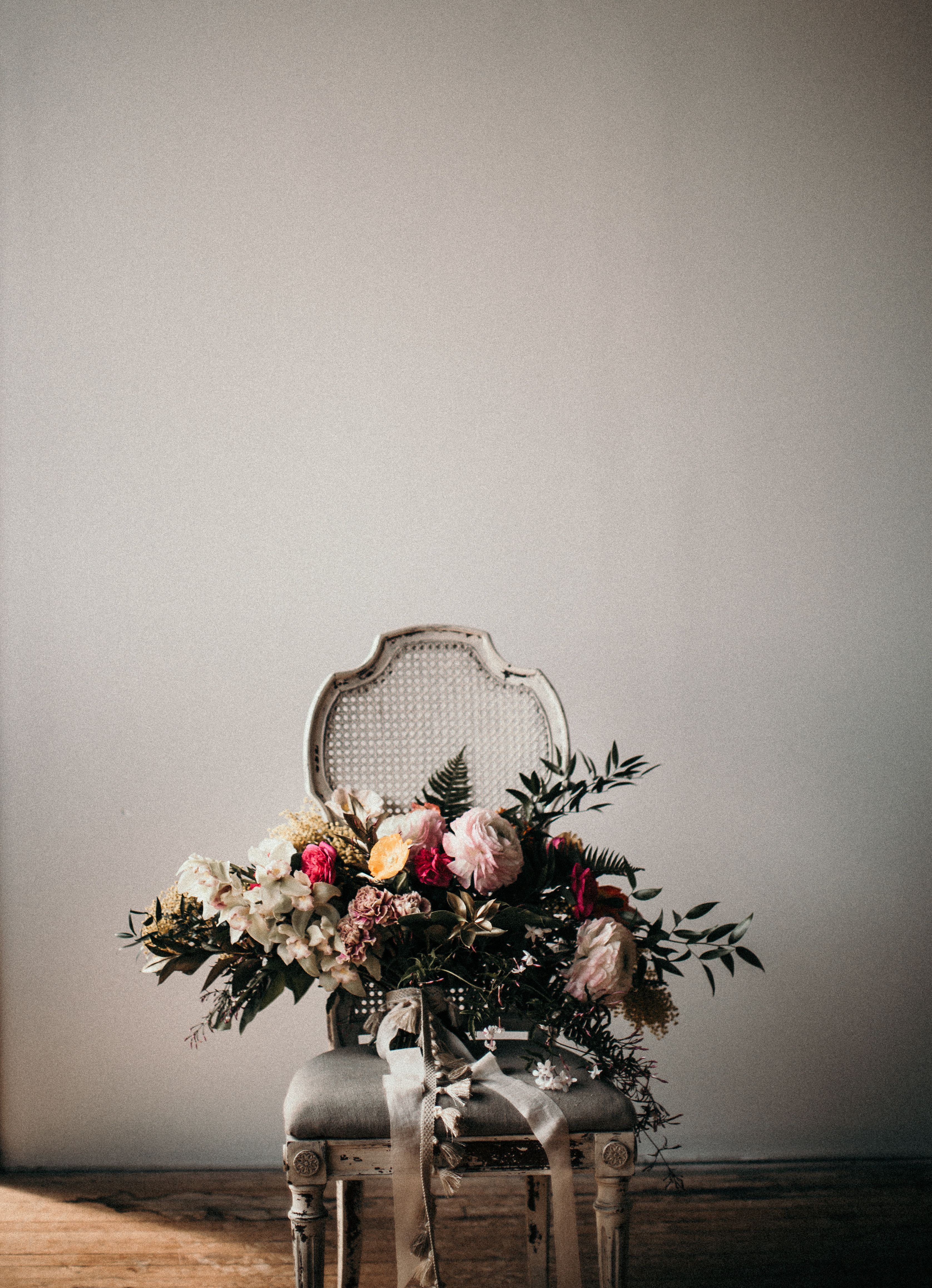 Photo Of Flowers On Chair · Free Stock Photo