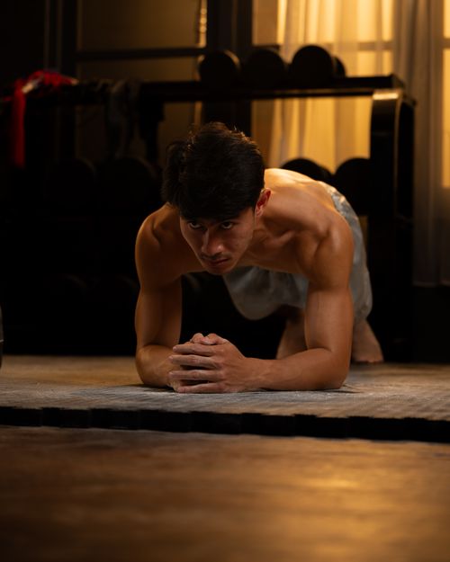 Free Athlete trains indoors with determination in a well-equipped gym. Perfect fitness inspiration. Stock Photo