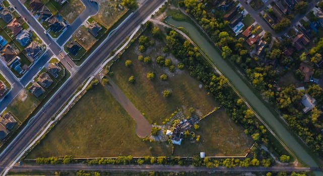 Drone shot showcasing a suburban neighborhood and green fields in Edinburg, Texas.