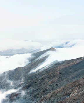 A breathtaking view of mountains enveloped in clouds, showcasing nature's serene beauty in La Libertad, Peru.