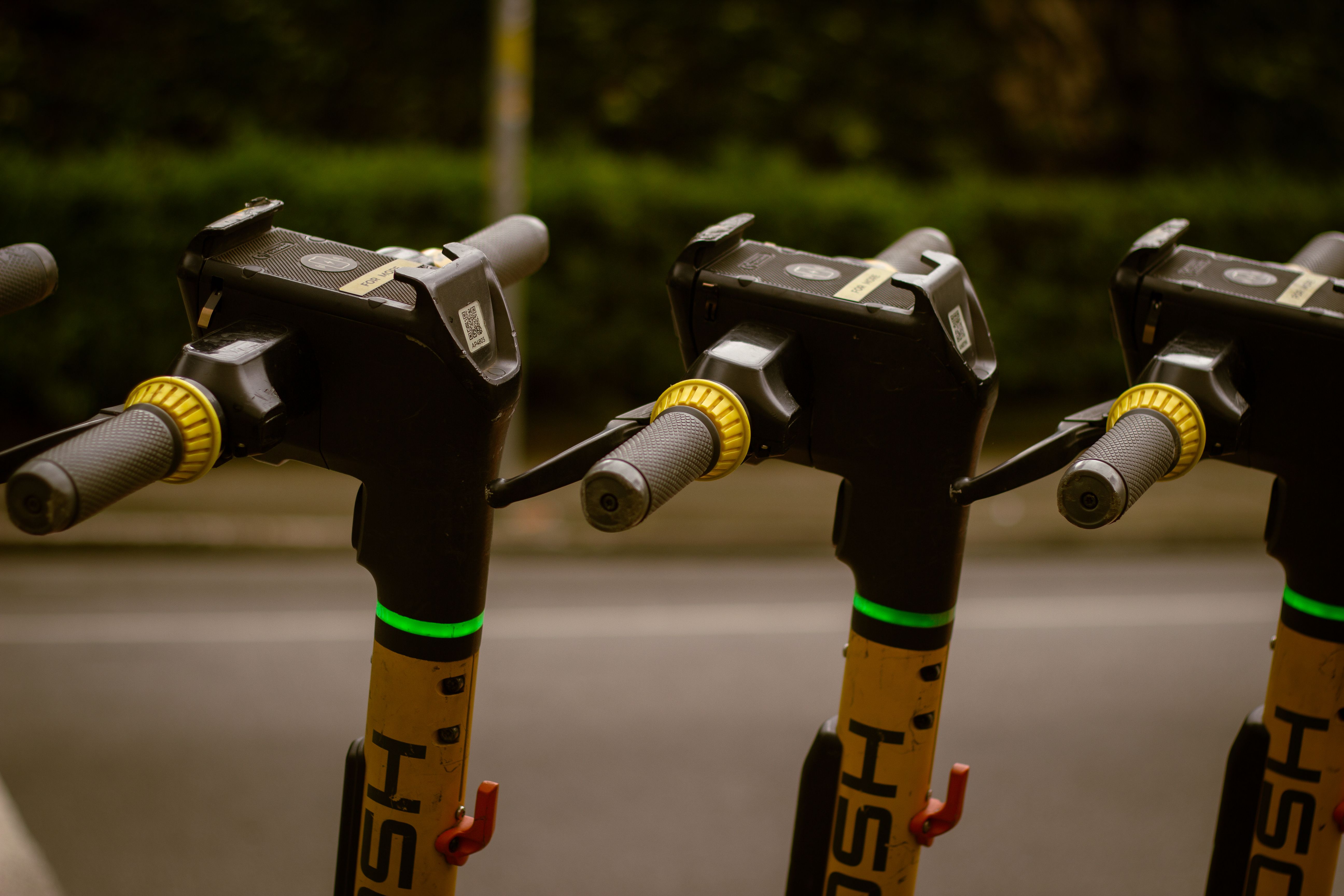 Close-up of electric scooters parked outdoors