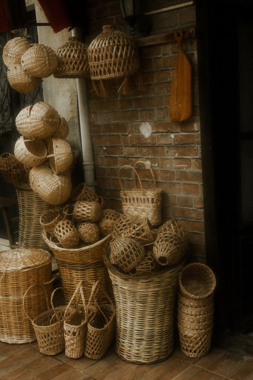 Free A charming collection of handwoven baskets against a brick wall, showcasing rustic craftsmanship. Stock Photo