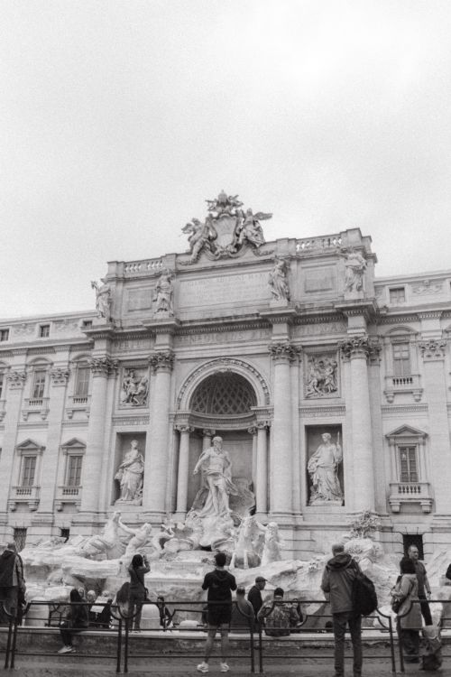 Free Black and white photo of Trevi Fountain in Rome with people admiring the intricate sculptures. Stock Photo