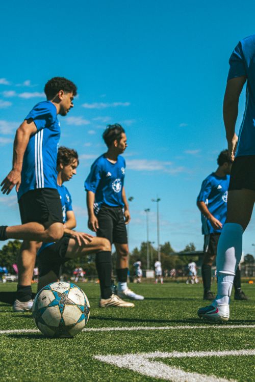 Free A group of young soccer players in blue jerseys practice on an outdoor field in Melbourne, Australia. Stock Photo
