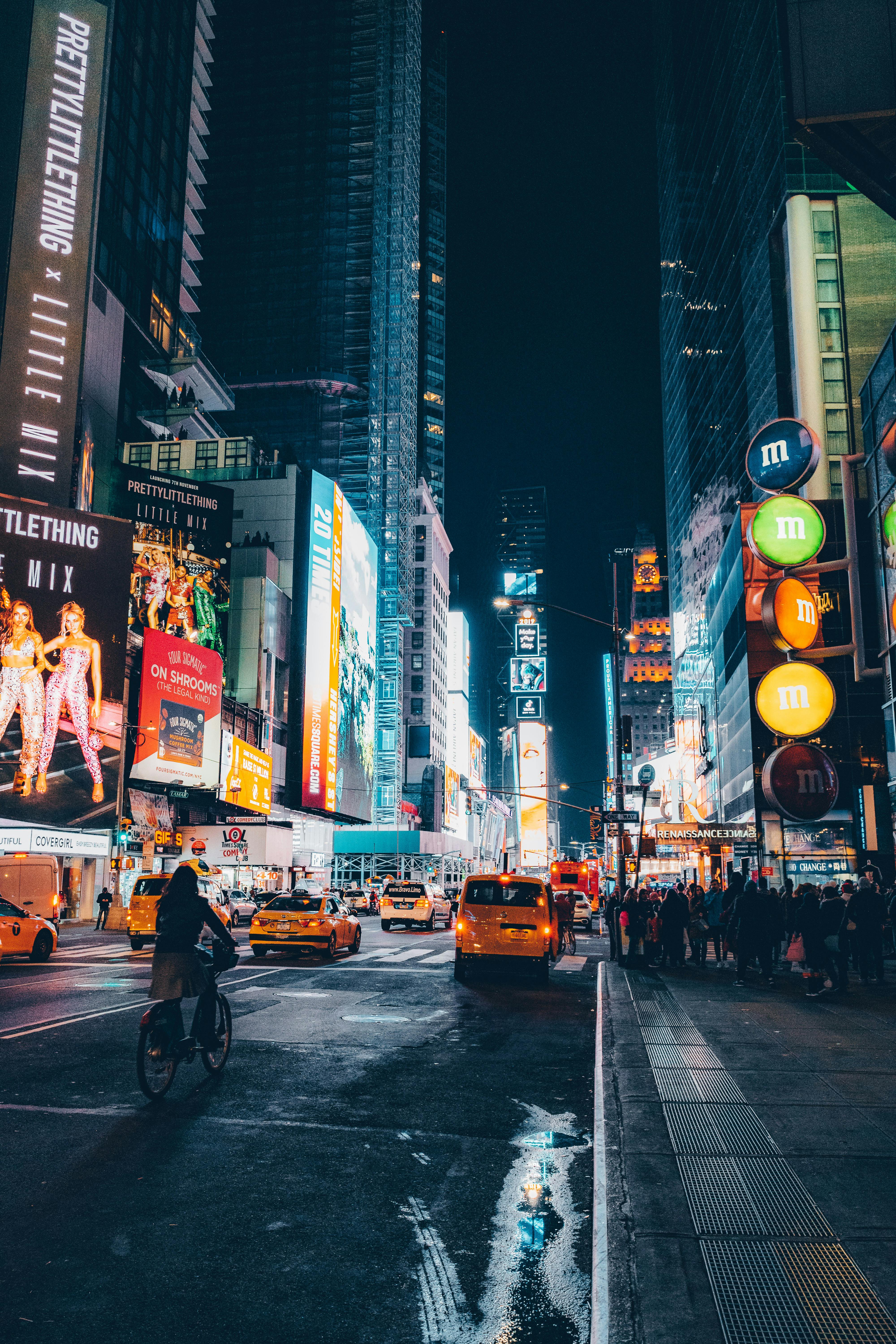 Bustling Times Square at night with bright neon lights and busy streets.