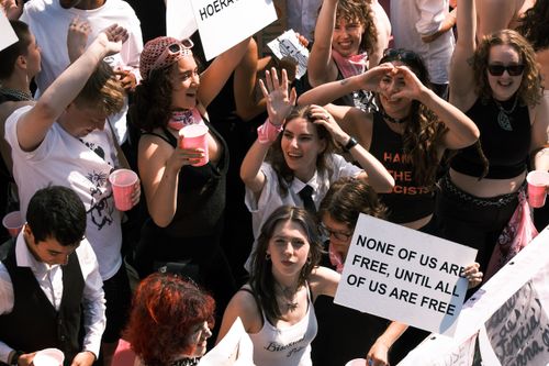 Free Energetic crowd at an equality protest in Amsterdam, holding signs and showing unity. Stock Photo