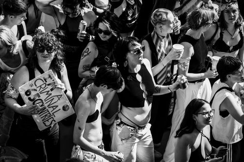 Free Black and white photo of a lively pride parade in Amsterdam, showcasing diverse participants. Stock Photo