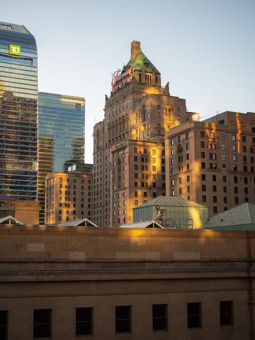 Free Scenic view of historic and modern skyscrapers at sunset in downtown cityscape. Stock Photo