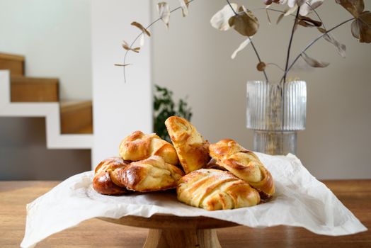 Delicious golden-brown buns artfully arranged in a cozy home setting, perfect for breakfast.