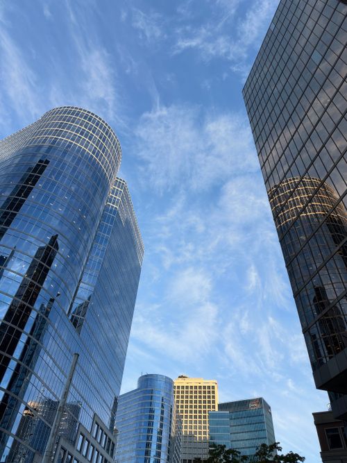 Free Stunning view of modern skyscrapers reflecting the sky in a bustling city center. Stock Photo