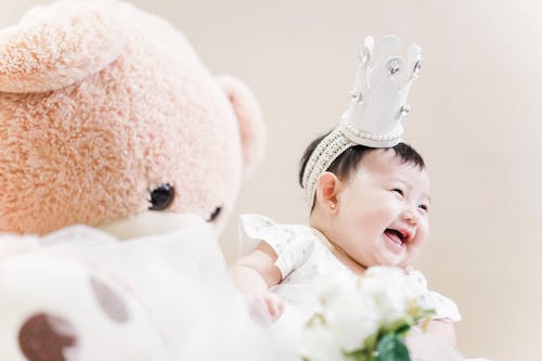 Free Photo Of Baby Beside Stuffed Toy Stock Photo