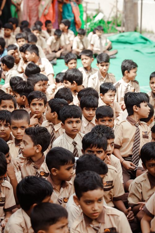 Free A large group of school children in uniforms attending an outdoor event in Hyderabad, India. Stock Photo