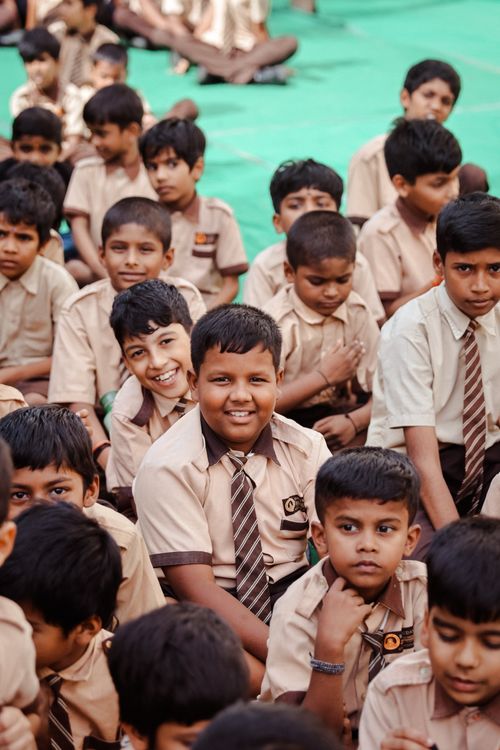 Free Group of cheerful schoolboys in uniforms attending an outdoor assembly in Hyderabad, India. Stock Photo