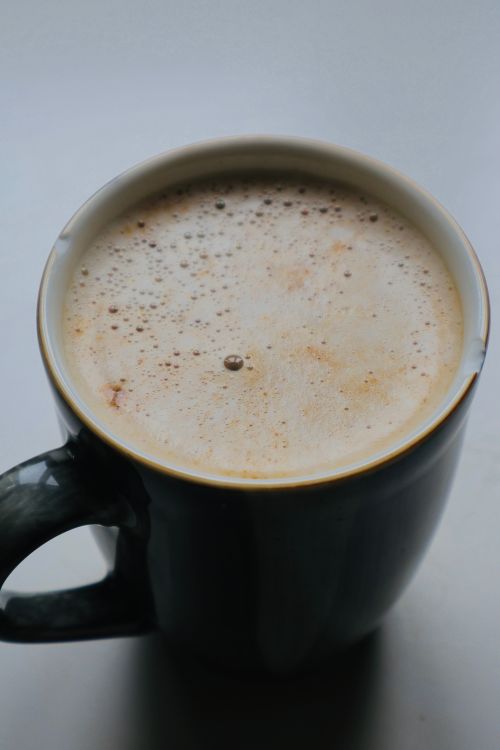 Free A close-up of a frothy coffee cup perfect for cozy mornings. Stock Photo