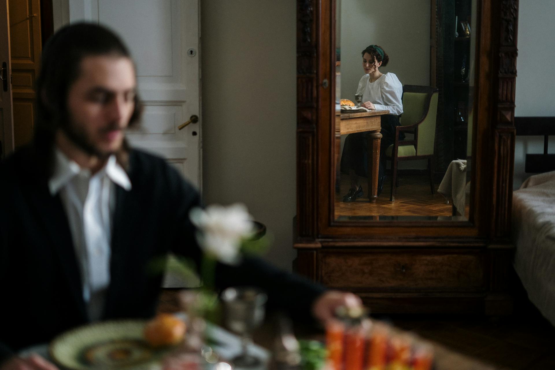 Captivating moment of a couple seen through a mirror, adding depth to home interior vibe.