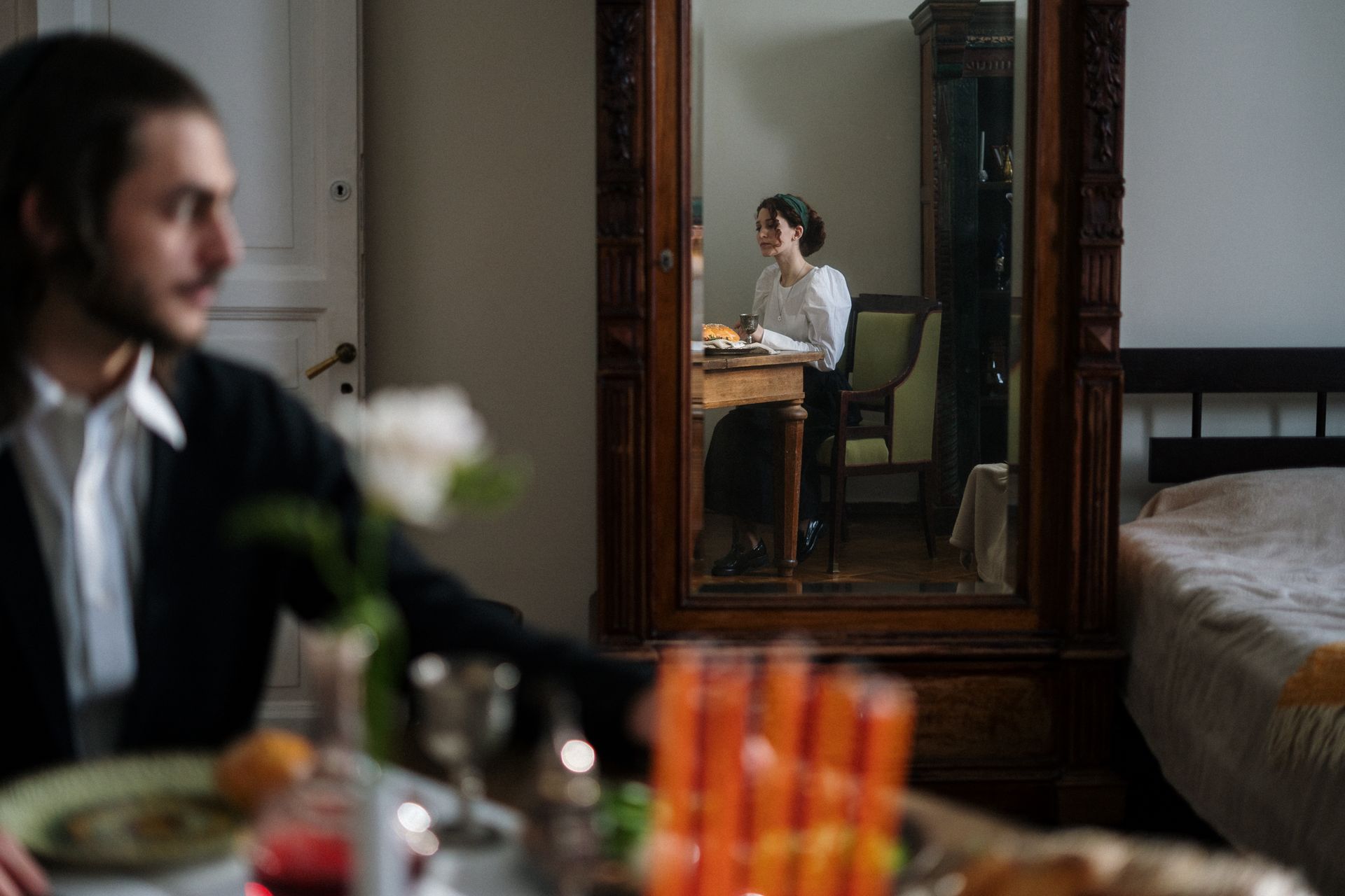 A couple enjoys a quiet moment reflected in a mirror, capturing the essence of home life.