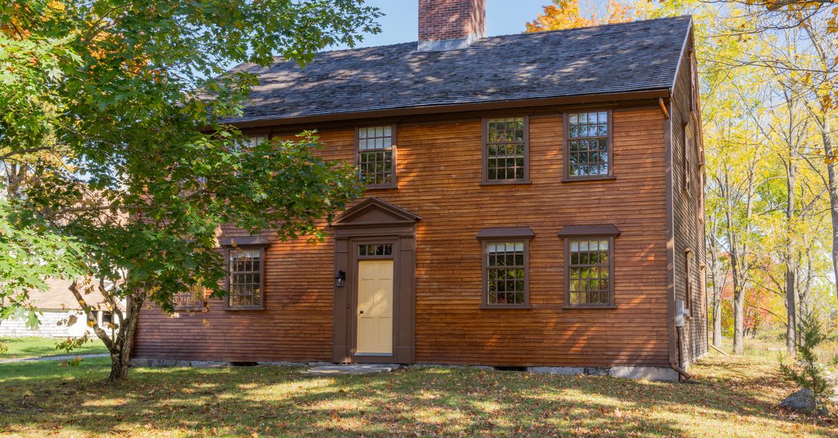 Charming historic colonial home surrounded by autumn foliage in Concord, Massachusetts.