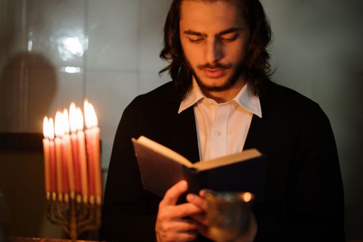 Man Reading a Book in Candlelight