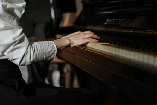A pianist's hands gracefully playing a grand piano, evoking passion and music appreciation.