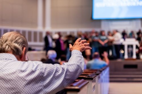 Free People gathered in a church service, hands raised in worship and praise. Stock Photo