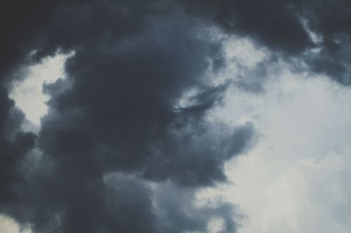 Free Moody dark clouds covering the sky, creating a dramatic scene. Stock Photo