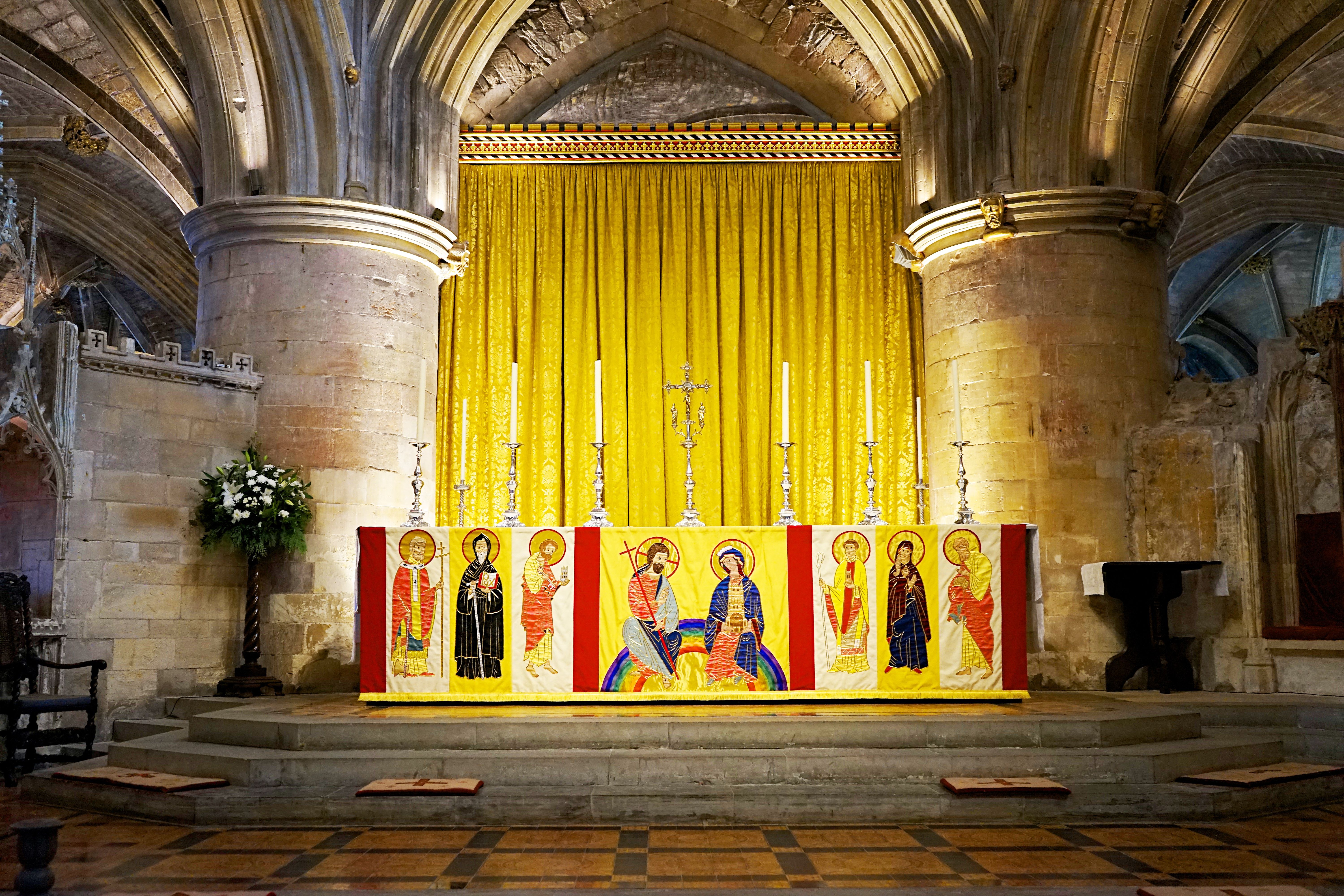 An ornate altar inside Tewkesbury Abbey, showcasing intricate religious art and architecture.