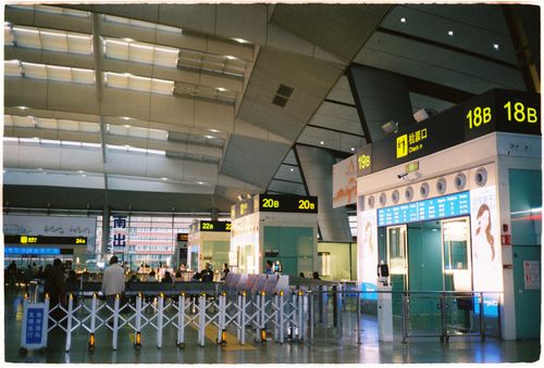 Free Spacious airport check-in area in China featuring bright signs and modern architecture. Stock Photo
