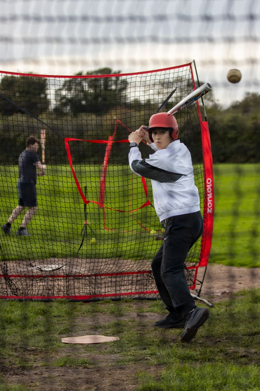 Teen baseball player practicing outdoors