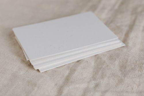Free Stack of white paper on textured fabric surface, perfect for minimalistic designs. Stock Photo